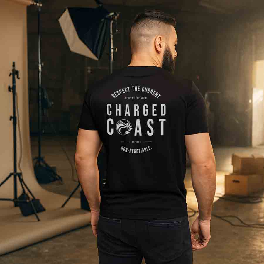 Man wearing a t-shirt standing in a warehouse next to a photo shoot set up in San Diego